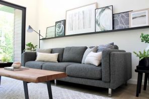 grey sofa bed for living room with wood table and art on the wall