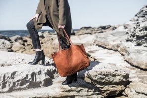 girl with black boots and jeans and brown tote leather bag