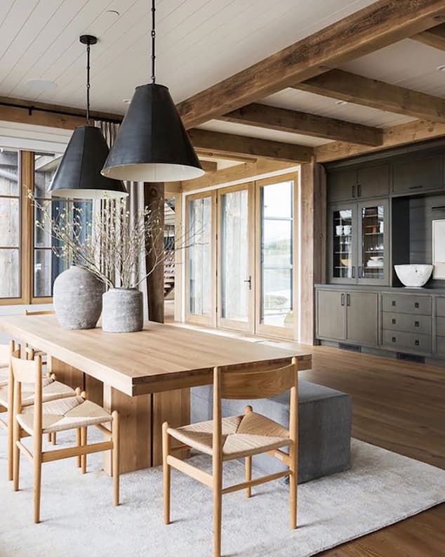 dining wood table with high wood chairs and decorative lighting
