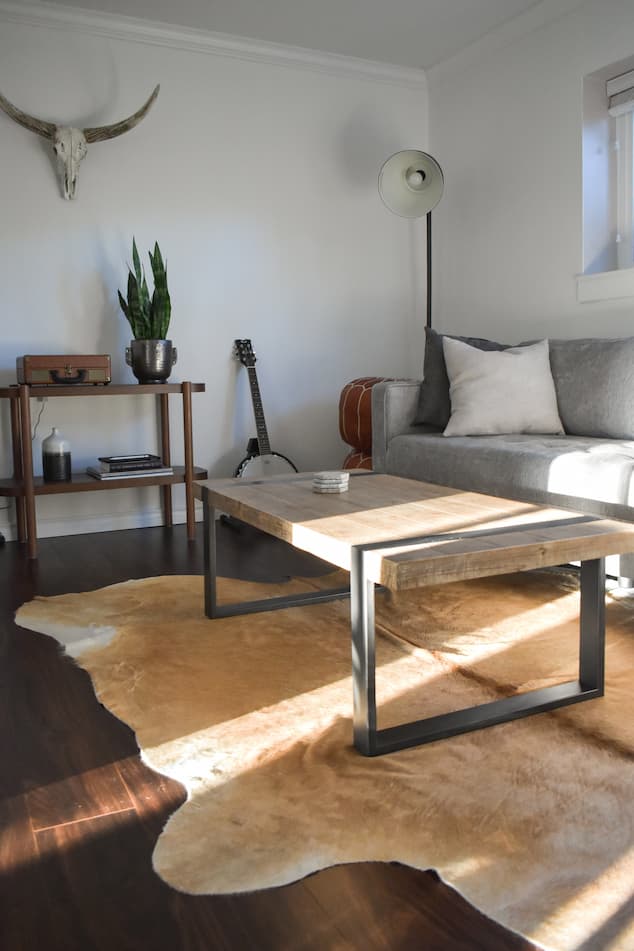 living room with wood coffee table and sofa bed