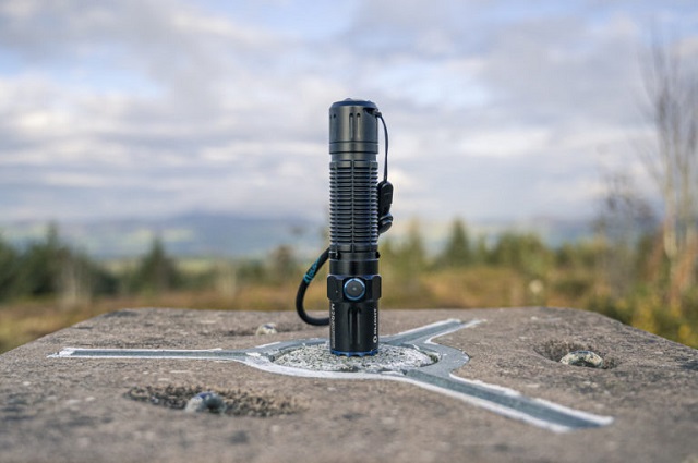 picture of an Olight torch on a rock in the nature