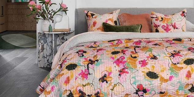 bed with a bed quilts in a beautiful colors