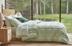 bed with a bed cover in a lighter color