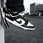 persons feet hanging with nike dunks