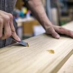 a man using different techniques to repair his wood project