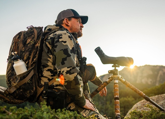 man using spotting scope