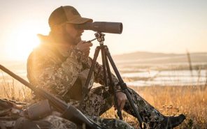 man using spotting telescope
